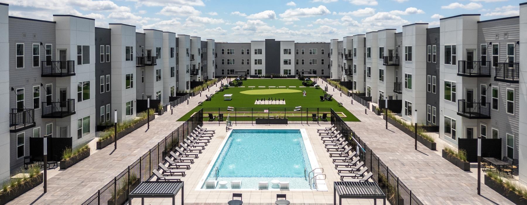 Resort-style swimming pool with lounge seating
