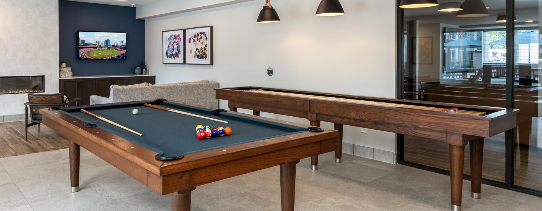 a pool table in a room with a shuffleboard table