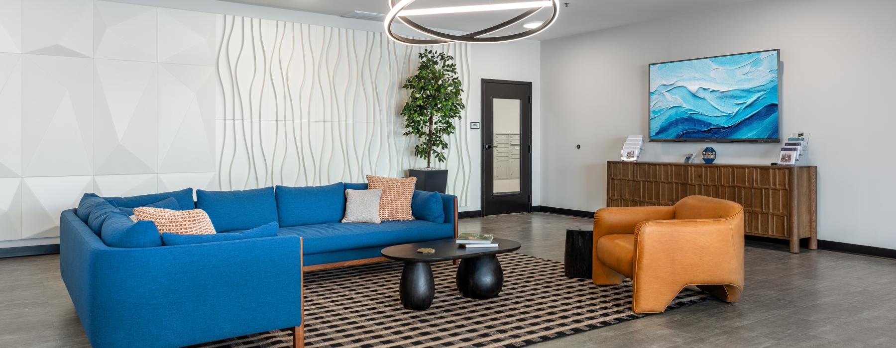 a spacious room with a blue couch