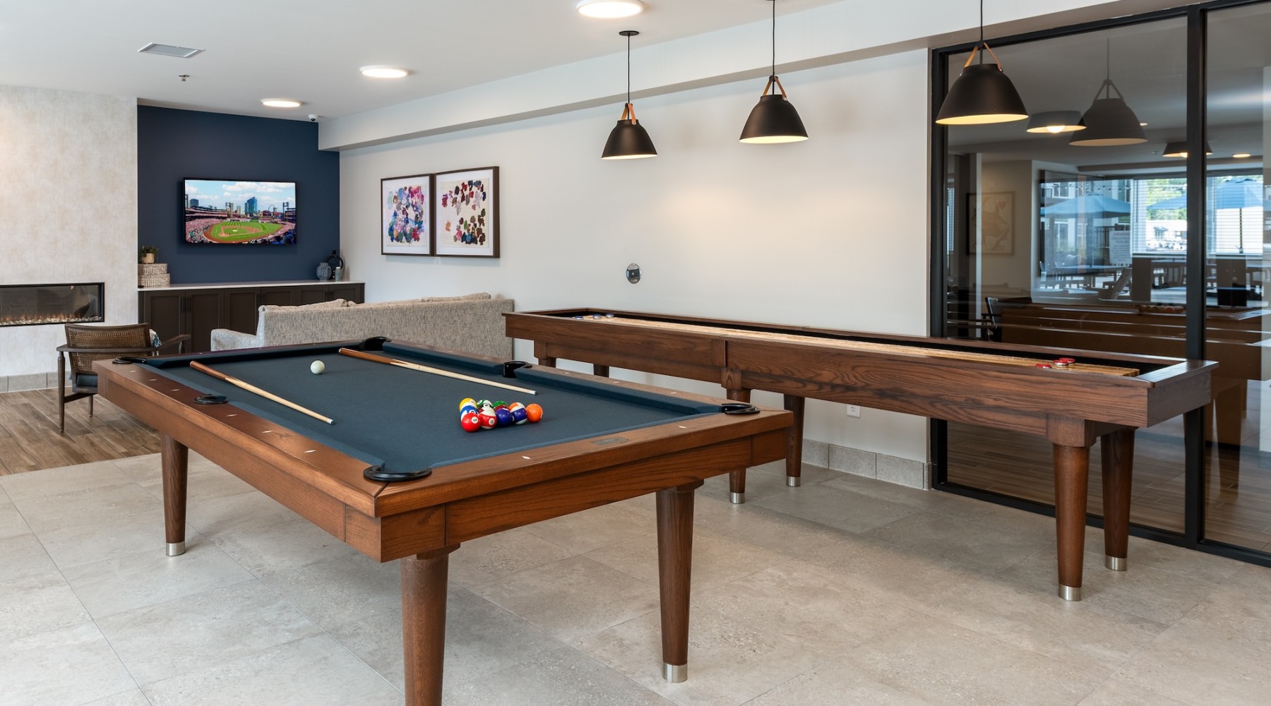 a game room with billiards and a tv