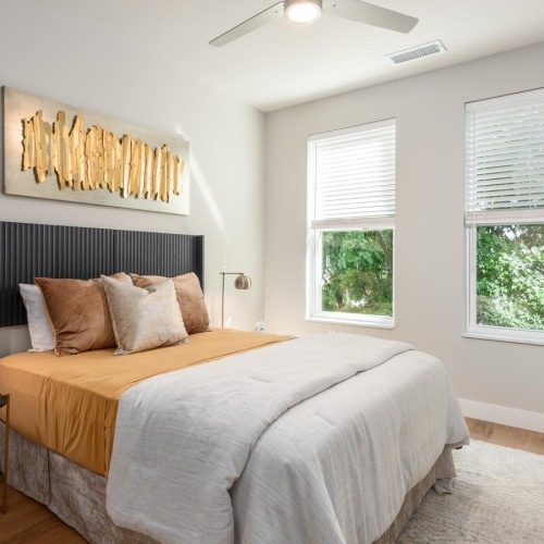 a bedroom with a bed and a fan